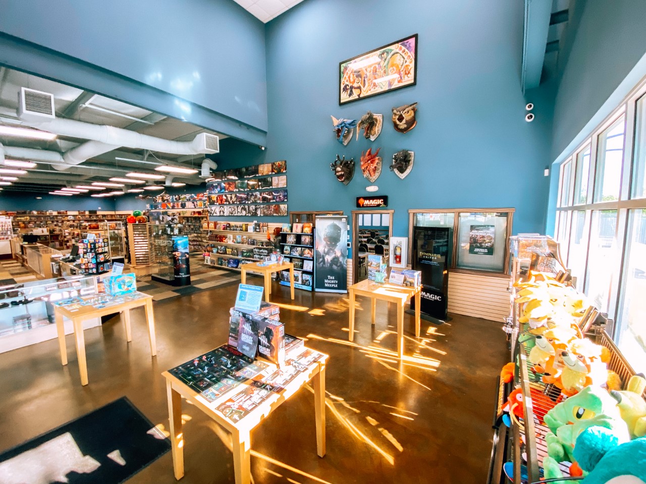 Interior of The Mighty Meeple with game shelves and merchandise